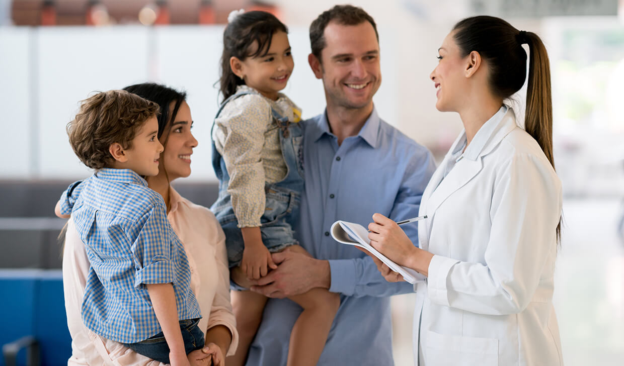 young family speaks to young physician 