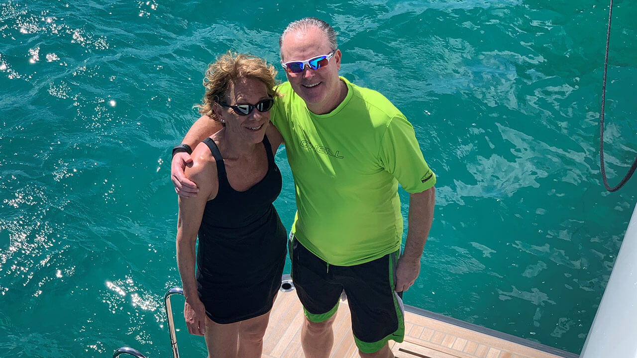 Lori standing on a dock with her husband