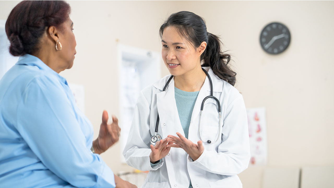 Middle age woman talking to young female doctor