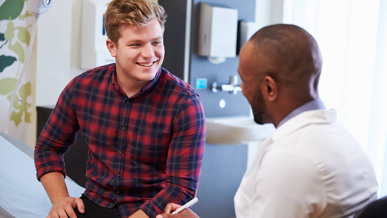 Young male talking to male doctor