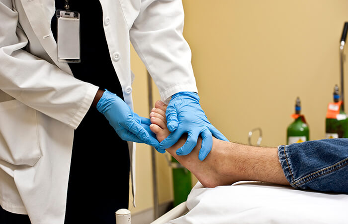 doctor holding patient foot