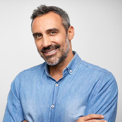 Middle aged male smiling with arms crossed