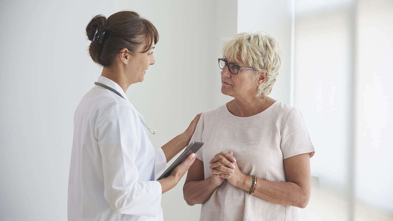 Middle age woman talking to female doctor