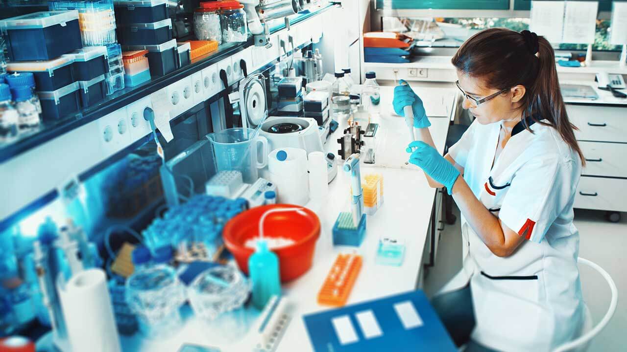 Lab technician holding a tube in a laboratory