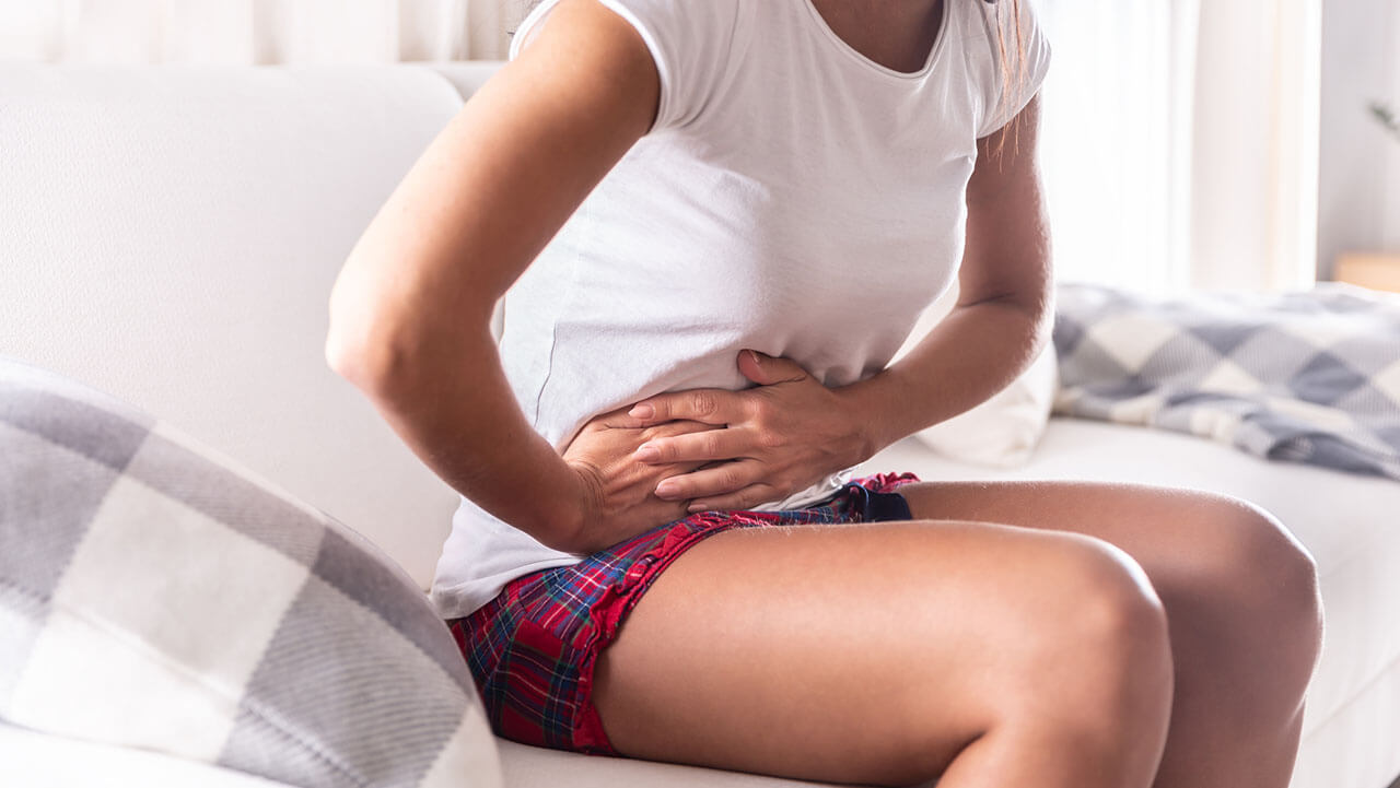 Woman holding stomach in pain