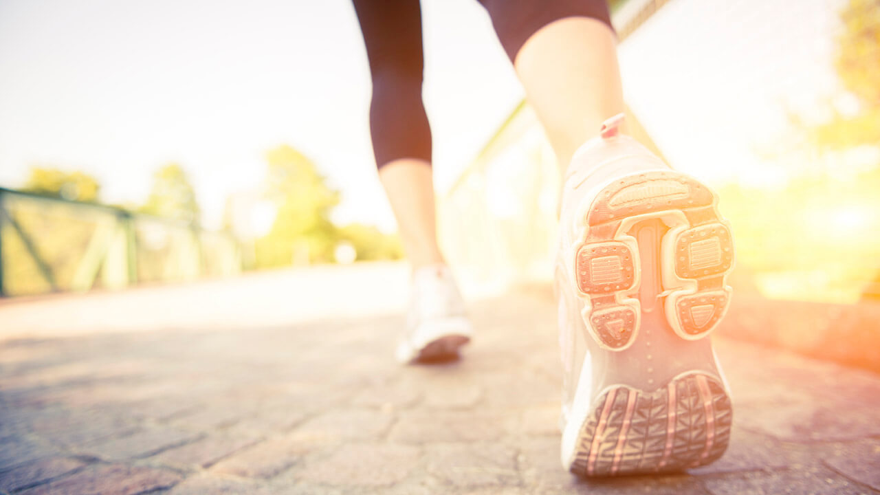 photo of woman walking in shoes