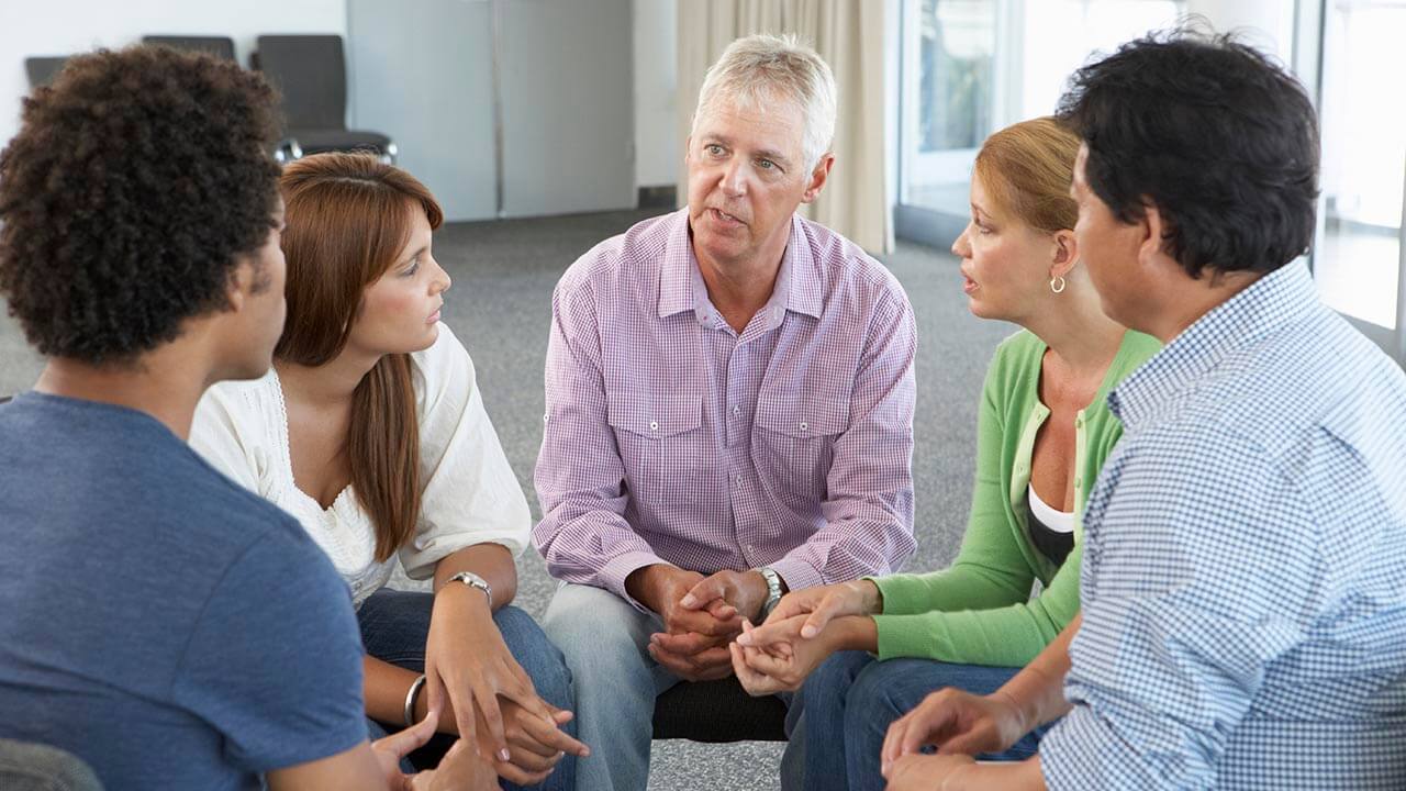 Support group sitting in a circle talking