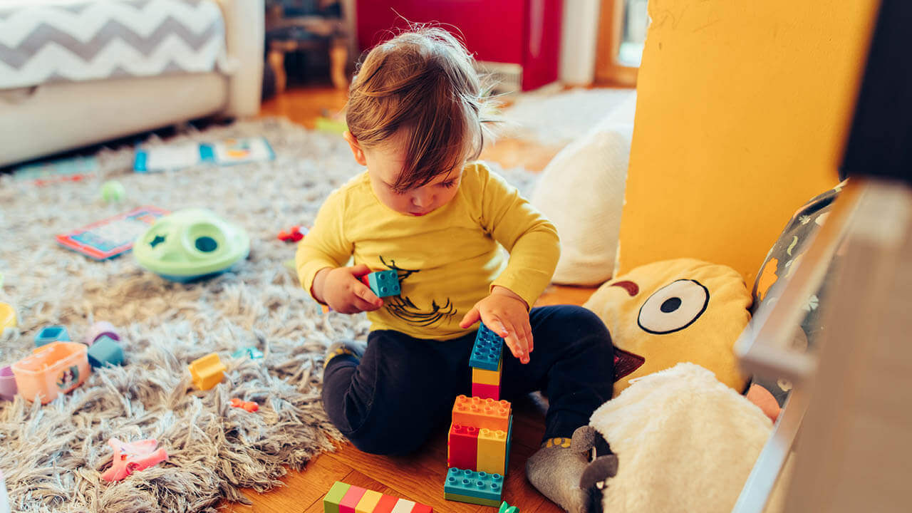 toddler playing with Duplo legos