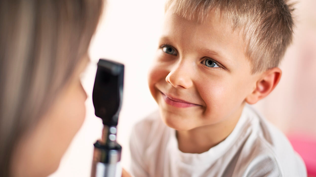 Child Getting Eye Examined by Doctor
