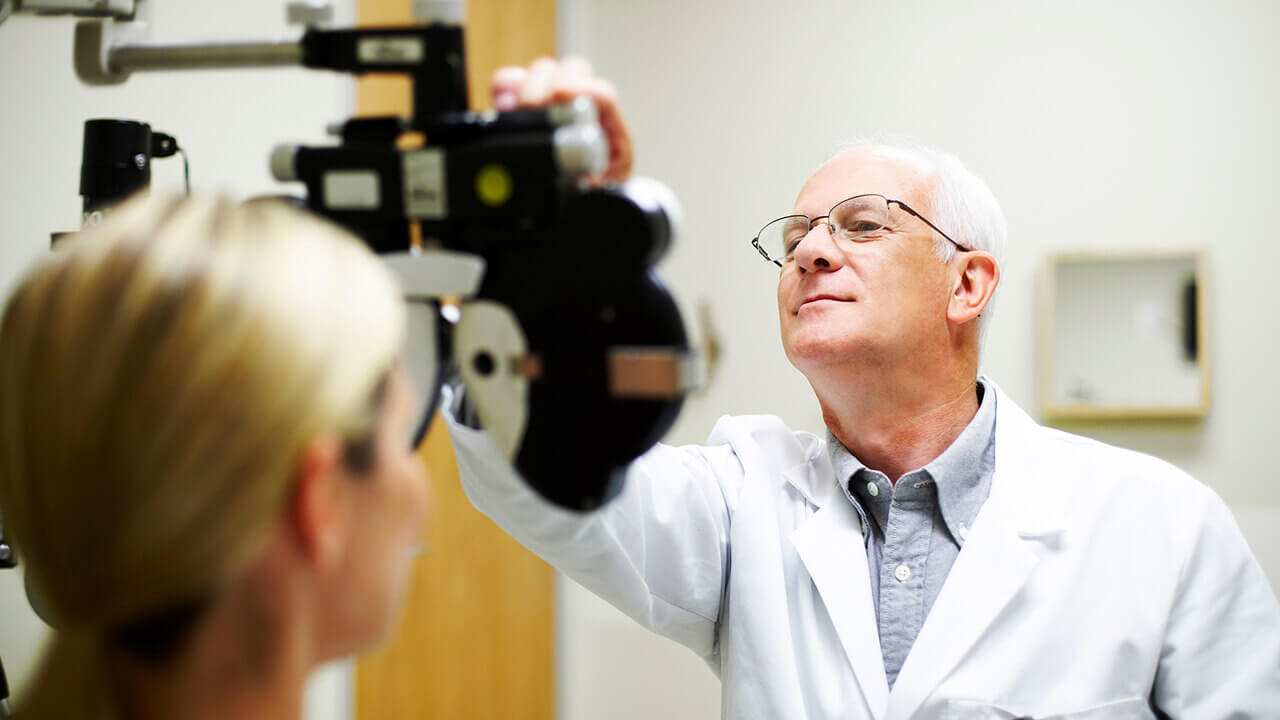 Opthamologist measuring patient's eyesight