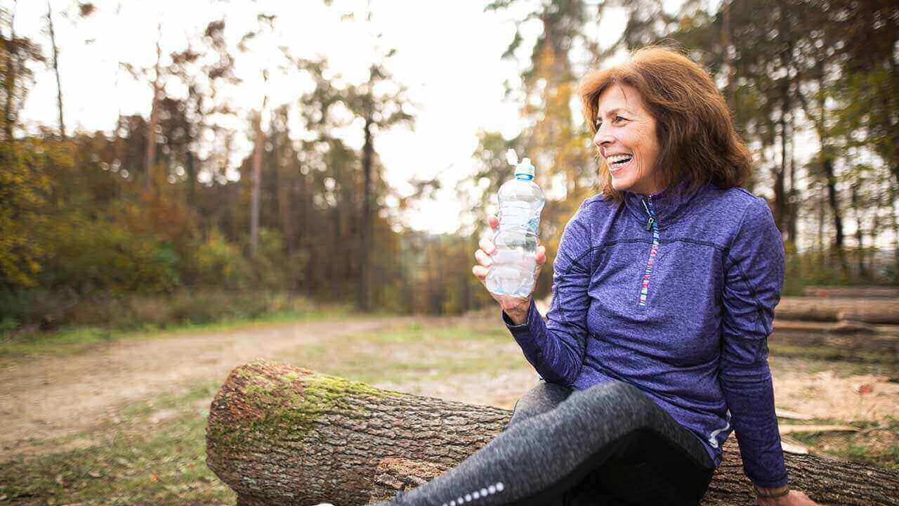 woman holding a water bottle