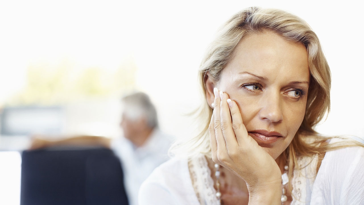 Middle age woman with sad expression on face