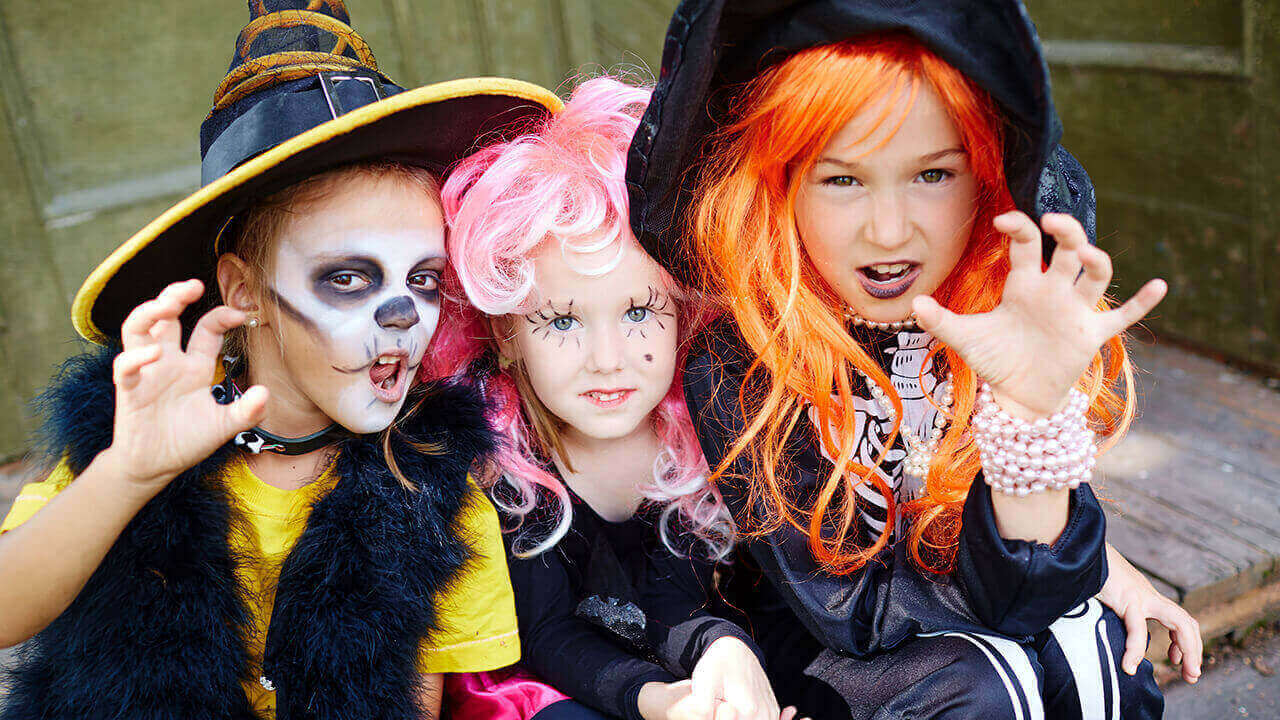 Three young girls in scary costumes