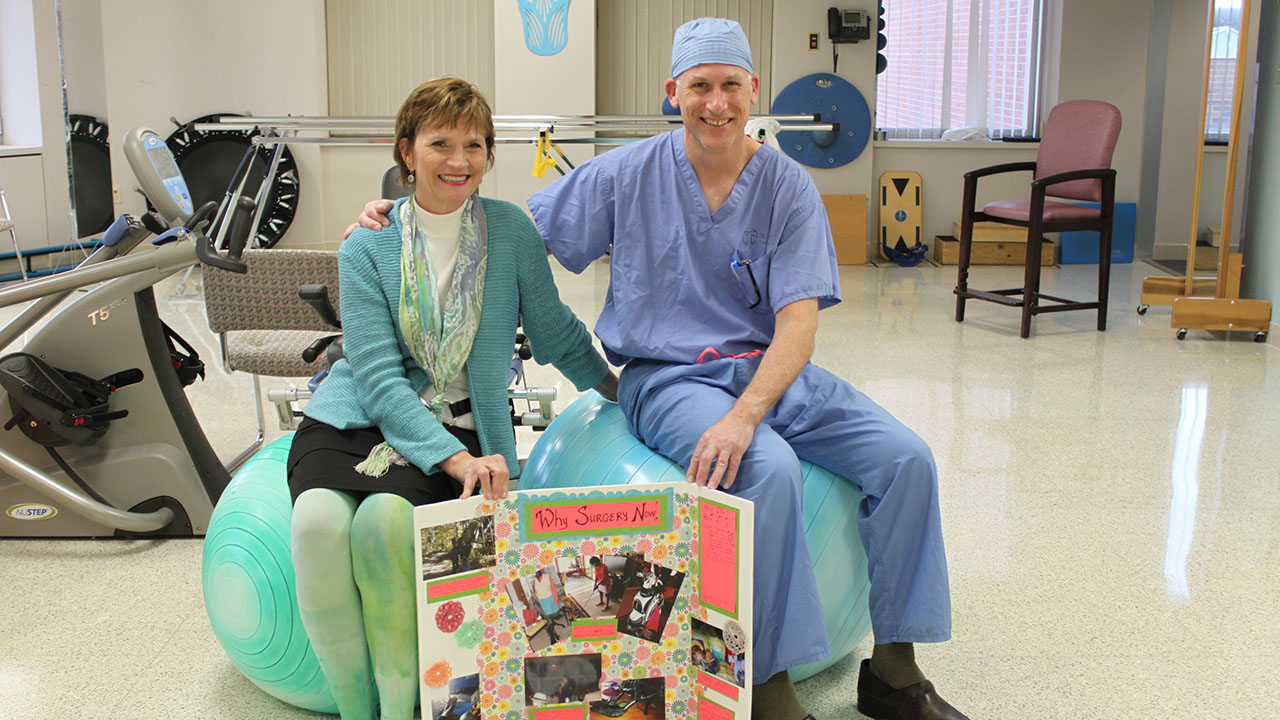 Patient Sandy smiling with Dr. Mark Schick