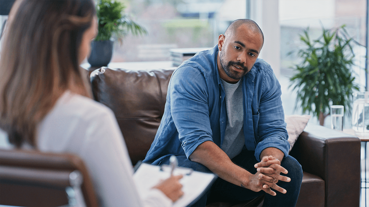 black male patient speaks to non visible brunette therapist